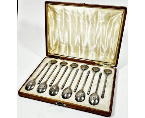 A cased set of twelve Russian silver teaspoons stamped Moscow 84 initialled M A with flowers engraved to the lightly gilded b