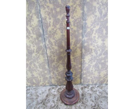 A mahogany standard lamp the turned and carved column raised on a disc shaped platform base (constructed from Victorian and l