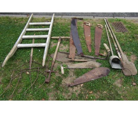 One lot of vintage tools to include two man saws,  hay knives, unusual wide five pronged fork, etc a five rung agricultural r