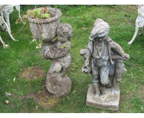 A weathered cast composition stone garden water feature in the form of a boy standing beside a rustic fence, 77cm high (AF) t