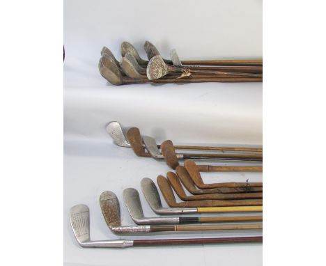 A quantity of vintage hickory shafted golf clubs, nine various woods and thirteen irons or putters