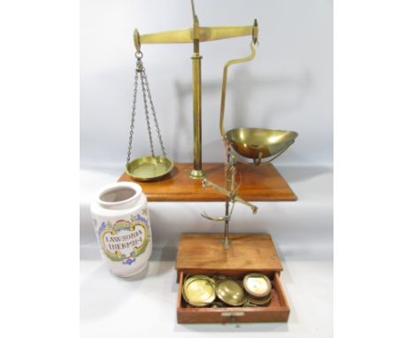 A 19th century set of brass scales on a mahogany stand with a single drawer, made by Ge Grave, Short &amp; Co with a selectio