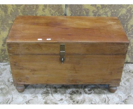 A small vintage teak chest with hinged lid and brass clasp and raised on turned supports 47 cm high x 76 cm x 36 cm 