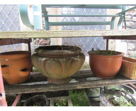 A weathered terracotta squat oviform garden planter, 34 cm high x 55 cm diameter together with three further terracotta plant