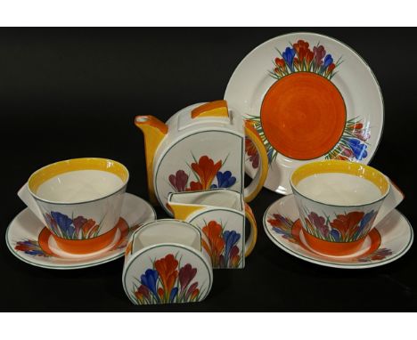 A Clarice Cliff style crocus pattern group of tea ware, teapot, sugar and milk, two cups and saucers and a sandwich plate