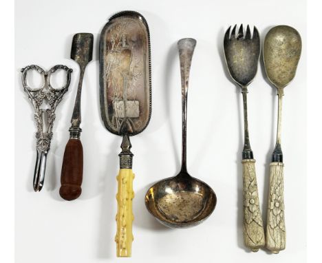 A pair of silver plated grape shears in original leather box, a pair of salad servers, a silver plated ladle, a cheese scoop,