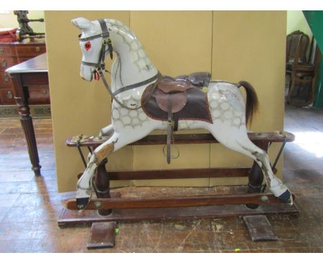 A traditional dapple grey rocking horse with painted detail, on a central rocker, 130cm high x 140cm long