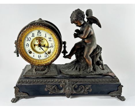 A decorative American Antonia figural spelter mantle clock, 34cm high, 44cm wide, together with a pair of spelter figures of 