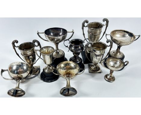 Eight silver tennis trophies won by R G Reeve, two further smaller trophies and a vintage cricket ball with a silver dedicati