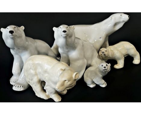 A collection of six ceramic polar bears in various poses