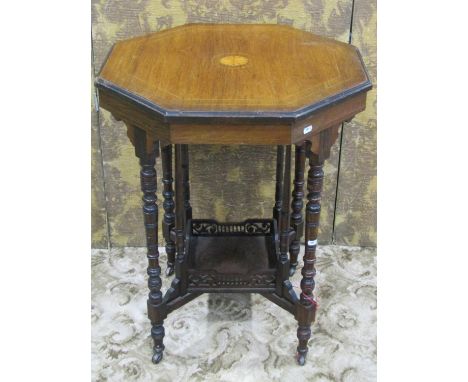 An inlaid Edwardian rosewood occasional table of octagonal form raised on ring turned tapered supports united by a under tier