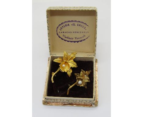 Two vintage Venezuelan orchid brooches, each stamped '18k', 9.4g total, with a Venezuelan box