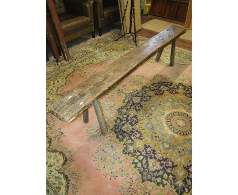 An antique oak country made bench or form, raised on four splayed supports, 45cm high x 200cm long x 20cm deep