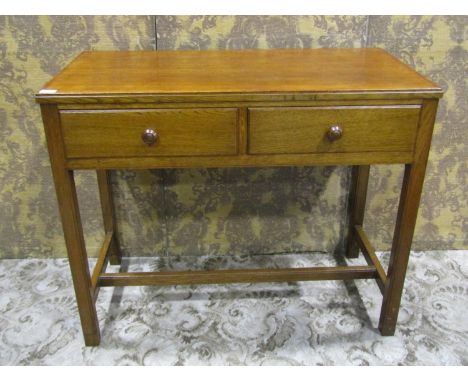 A vintage ex war department oak two drawer side table raised on square cut and moulded supports  and stretcher manufactured b