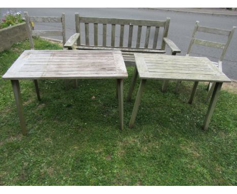 A vintage weathered teak two seat garden bench with slatted seat and back (probably a Lister example but unlabelled) 128 cm l