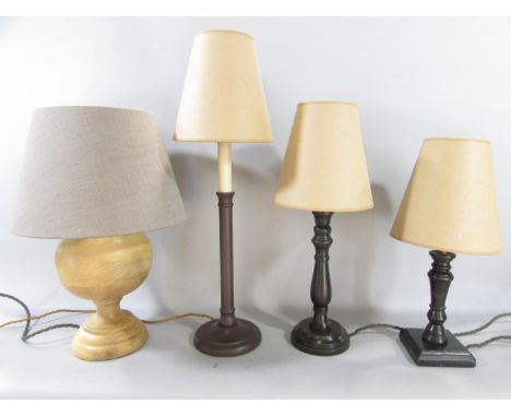 Three Pooky wooden table lamps, a Daisy, a Fred and a Venus model, and a fourth similar candlestick lamp, all with shades.