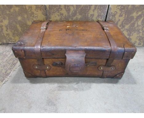 A large good quality heavy gauge brown leather trunk stamped Harrods Ltd London SW, with carrying handles, brass fittings, co