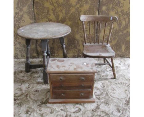 An old small chest of three drawers, a child’s Windsor elm and beechwood stick back chair, and  a circular oak occasional tab