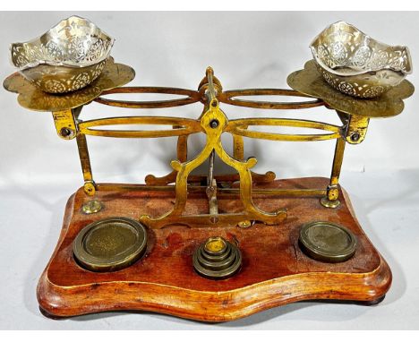 A set of Victorian letter scales with some weights and a pair of small silver dishes with pierced detail. 