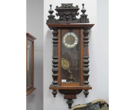 XIX Century Vienna Wall Clock, with an applied pediment, split pilasters, arched door, white enamel dial, twin Roman numerals