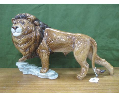 Goebel Lion, standing on a rocky outcrop, 47cm long.
