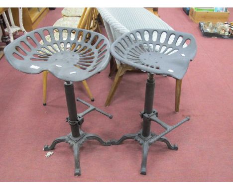 Pair of Cast Iron Tractor Seat Bar Stools, with foot rests.