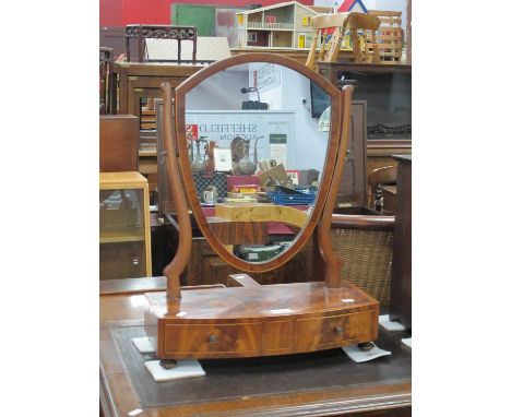 An XVIII Century Mahogany Dressing Table Mirror, with shield shaped mirror, crossbanded top and two small drawer on bun feet,