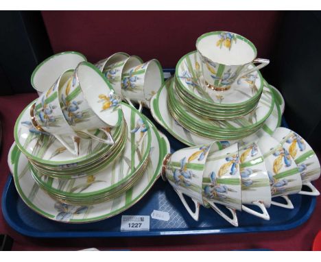 Royal Doulton 'Iris' Pattern Tea Service, comprising two bread and butter plates, twelve tea plates, eleven tea cups, twelve 