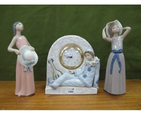 Lladro Porcelain Clock, with reclining clown and lute, 21cm high, together with two Lladro figures of ladies with hats. (3).