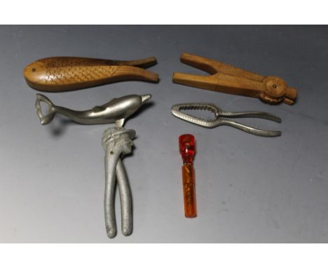 A COLLECTION OF NOVELTY AND VINTAGE NUT CRACKERS, to include an aluminium nutcracker formed as a grinning jockey, and a carve