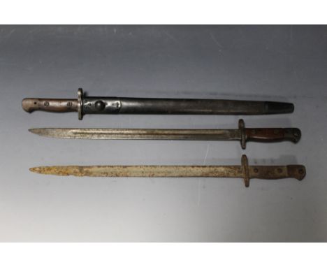 A 1908 WILKINSON BAYONET IN LEATHER SCABBARD, together with a 1907 example (no scabbard), and a relic condition bayonet of si