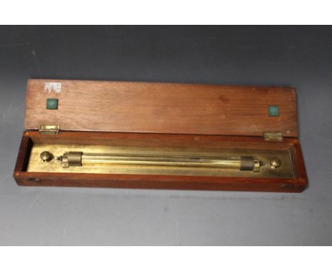 A LAQUERED BRASS ROLLER RULE, in mahogany fitted case, L 49 cm