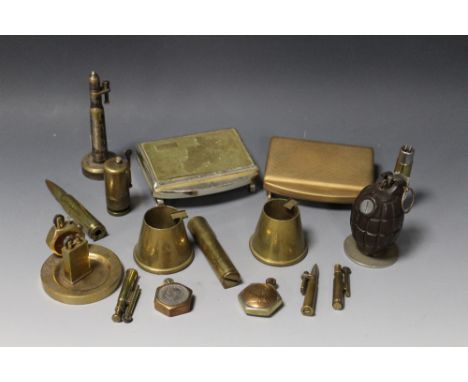 A TRAY OF ASSORTED MILITARY METALWARE, to include two musical cigarette boxes, brass ashtray with lighter, mounted grenade et