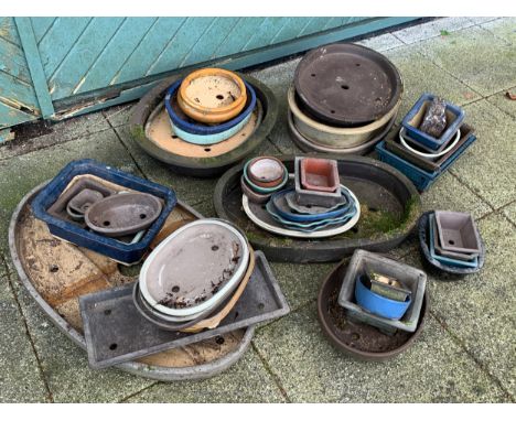 A substantial collection of shallow plant pots, mostly for bonsai trees, various sizes, composite and ceramic 