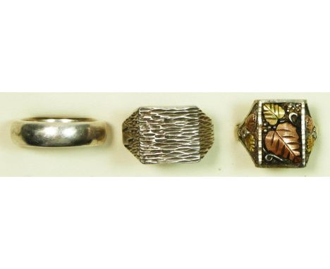 A silver signet ring, 42.7gmZ plus, a silver wedding band, Y and a silver floral signet ring, Y, 