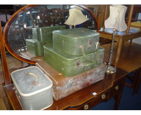 A SUITCASE, three other various cases and a brass table lamp with shade (sd) (5)