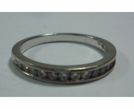 A PLATINUM AND DIAMOND HALF ETERNITY RING, size K 1/2