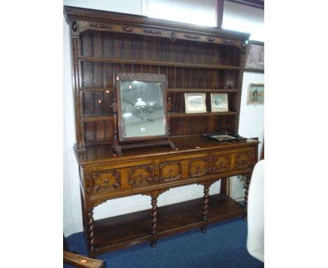 AN OAK DRESSER, the plate rack above three drawers with geometric detail, barley twist front supports and lower shelf