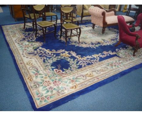 A LARGE CHINESE BLUE GROUND FLORAL PATTERNED CARPET, approximately size 496cm x 372cm (sd)
