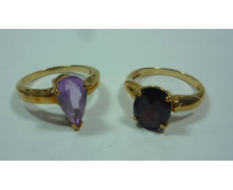 A 9CT GARNET DRESS RING, size N, together with a 9ct gold pear shaped amethyst dress ring, size N (2)