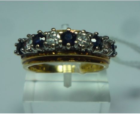 AN 18CT GOLD DIAMOND AND SAPPHIRE BAND RING, with alternate diamonds and sapphires to the plain tapered band, estimated total