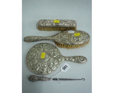 UNMATCHED SILVER MOUNTED DRESSING TABLE WARES, to include two brushes, mirror and button hook (4)