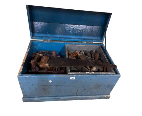 Tool chest containing collection of woodworking tools, saws, planes, etc.