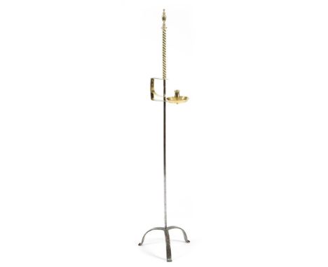 A brass and wrought iron adjustable candlestand, with an urn finial above an adjustable sconce, with a circular drip-pan, on 