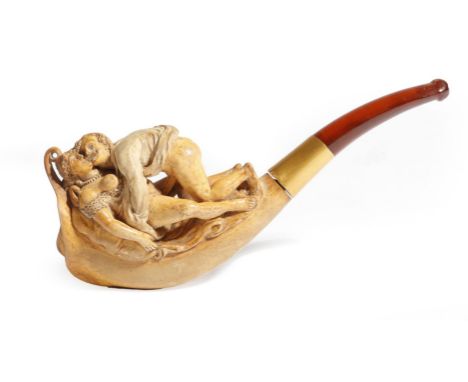 A 19th century Meerschaum erotic pipe, the bowl carved with a couple making love, with a gold collar and an amber mouthpiece,