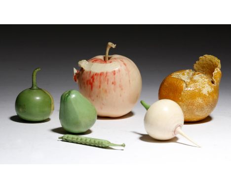 λ Two Japanese carved and painted ivory okimono of fruit, one of an apple, the skin partially peeled and stained a pink colou