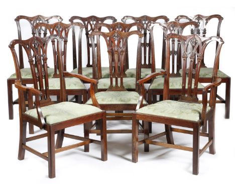 A set of ten mahogany dining chairs in Chippendale style, each with a leaf carved stop fluted splat back, above a drop-in sea