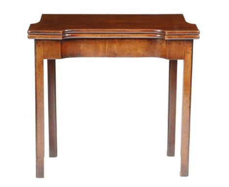 A George II mahogany card table, the fold-over top on a single gate support, with a concave frieze, on moulded and chamfered 