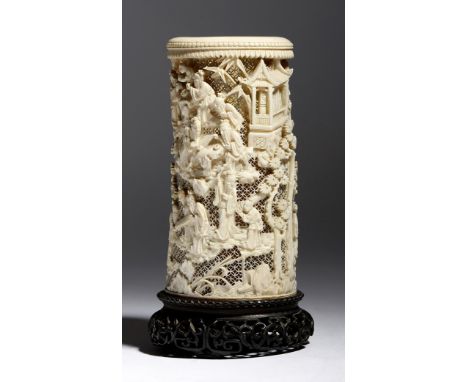 λ A late 19th century Chinese Canton carved ivory tusk vase, with a reticulated ground and decorated with figures in various 