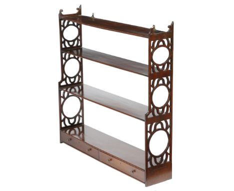 A George III mahogany hanging wall shelf, with pierced fretwork ends, the base fitted with two drawers, 90.3cm high, 91.8cm w